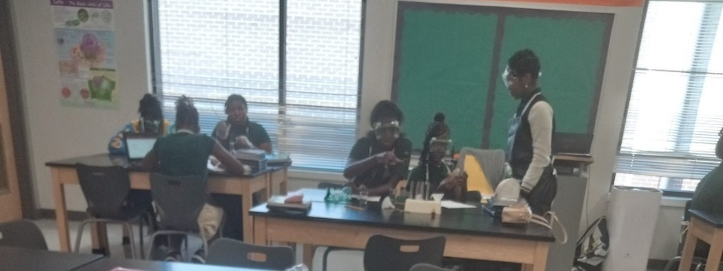 Students conducting lab using test tubes, thermometers, and scales. 