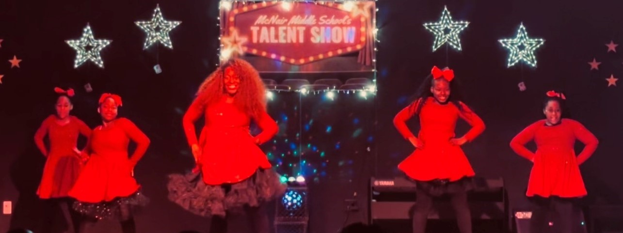 Teacher and 4 students dancing in talent show