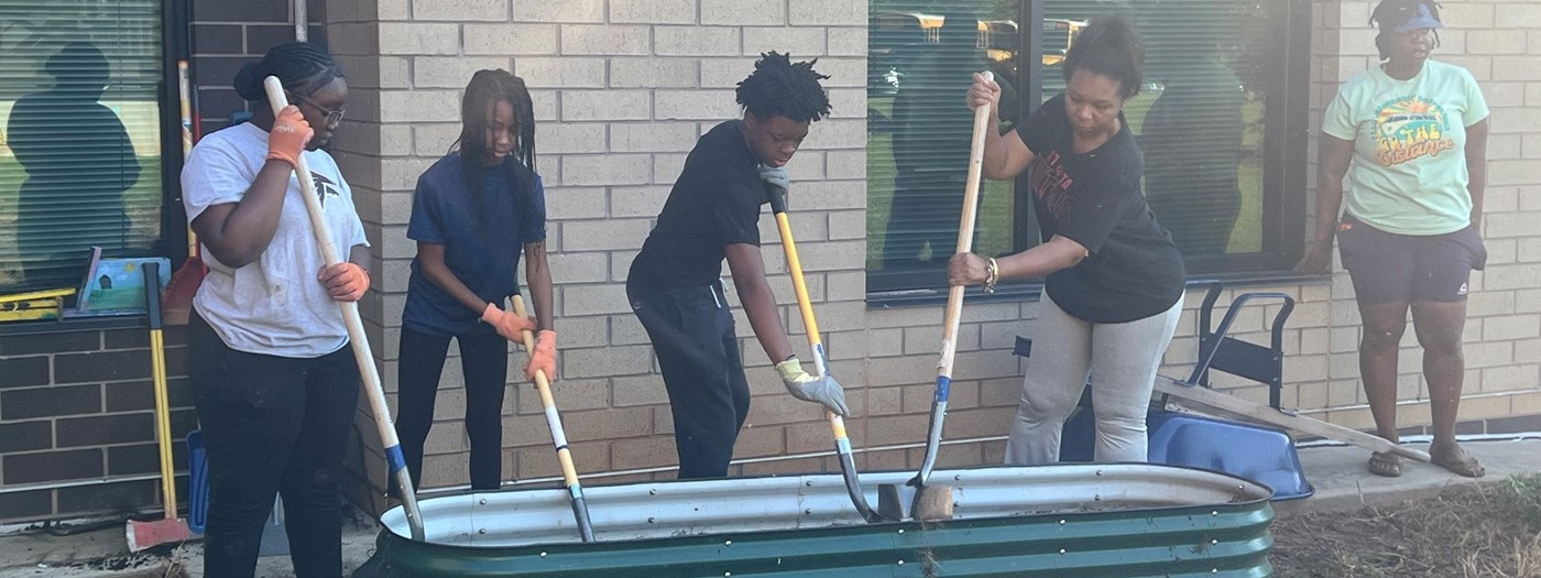 Teachers, students, and community people building the new garden at Ronald E. McNair Middle