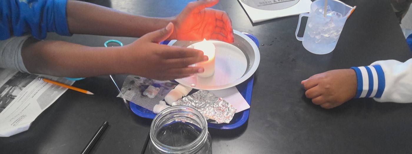 The hands of students are displayed showing them conducting Fire Investigation Lab