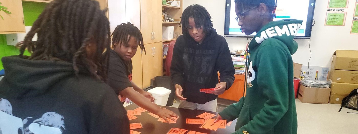 A group of male students working together to complete a vocab challenge