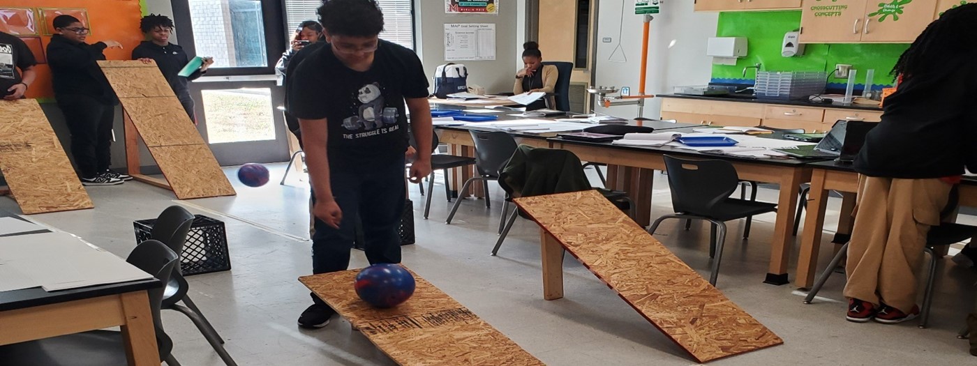 Students investigating Newton&#39;s Laws of Motion thru bowling